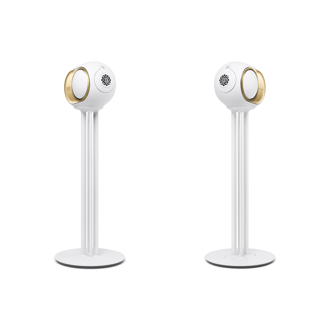 Pair of white and
  gold Devialet Phantom speakers on pedestal stands