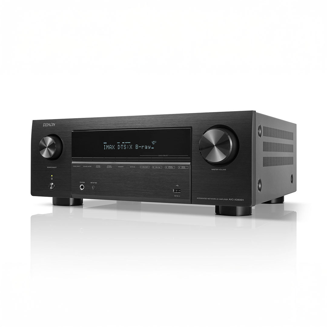 Denon audio receiver with display and control knobs.