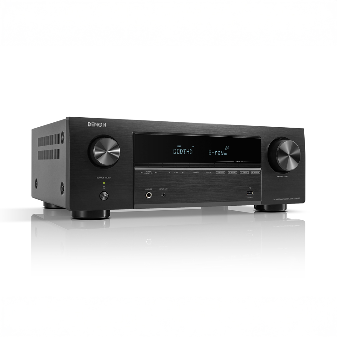 Denon AV receiver with digital display and controls.