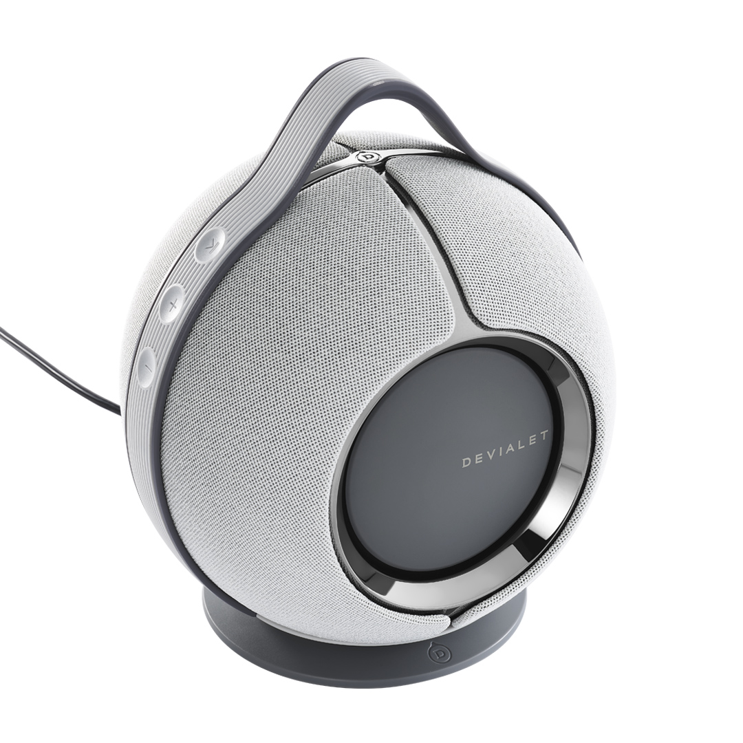 Round wireless speaker with handle and control buttons.