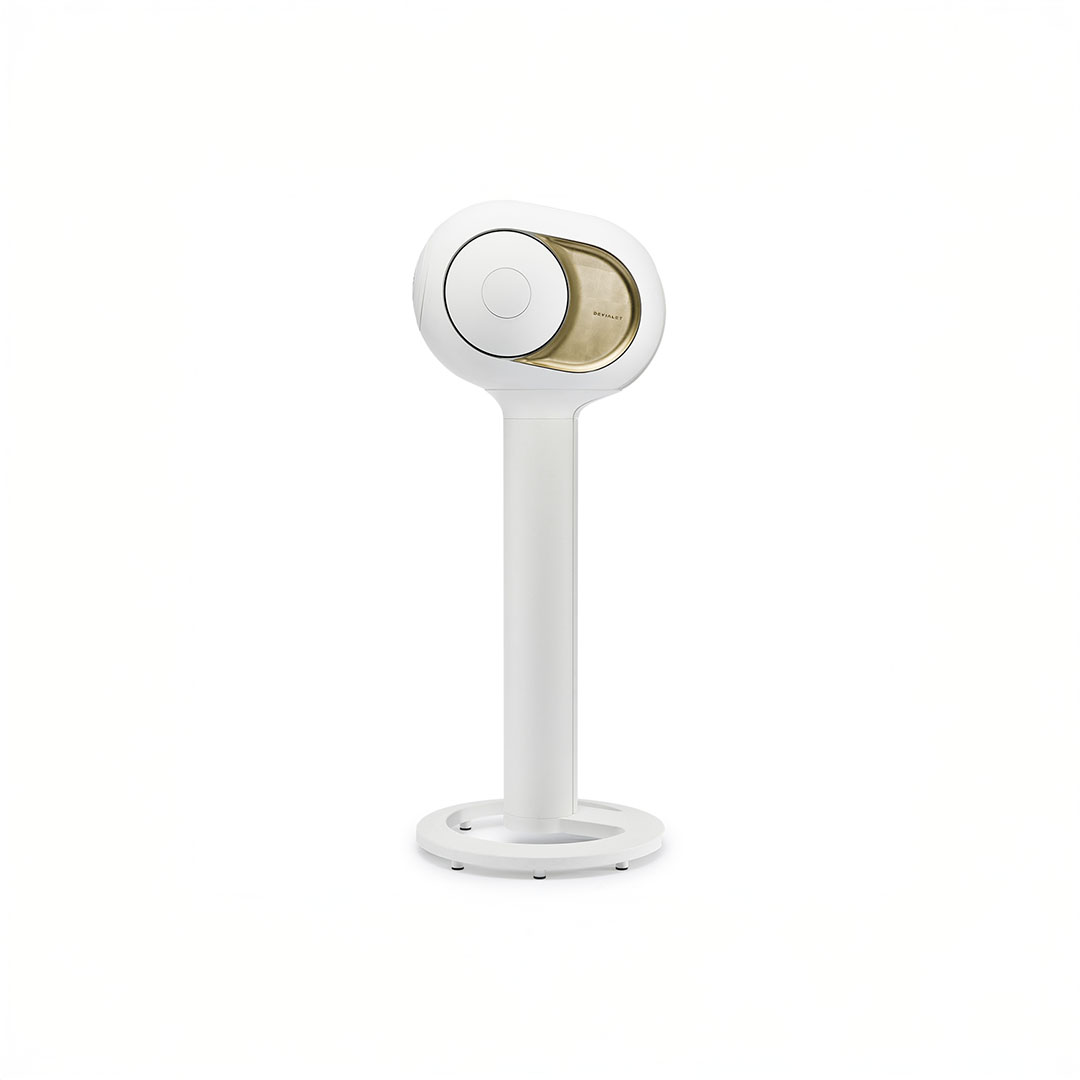 Modern speaker on white stand, minimalistic design.