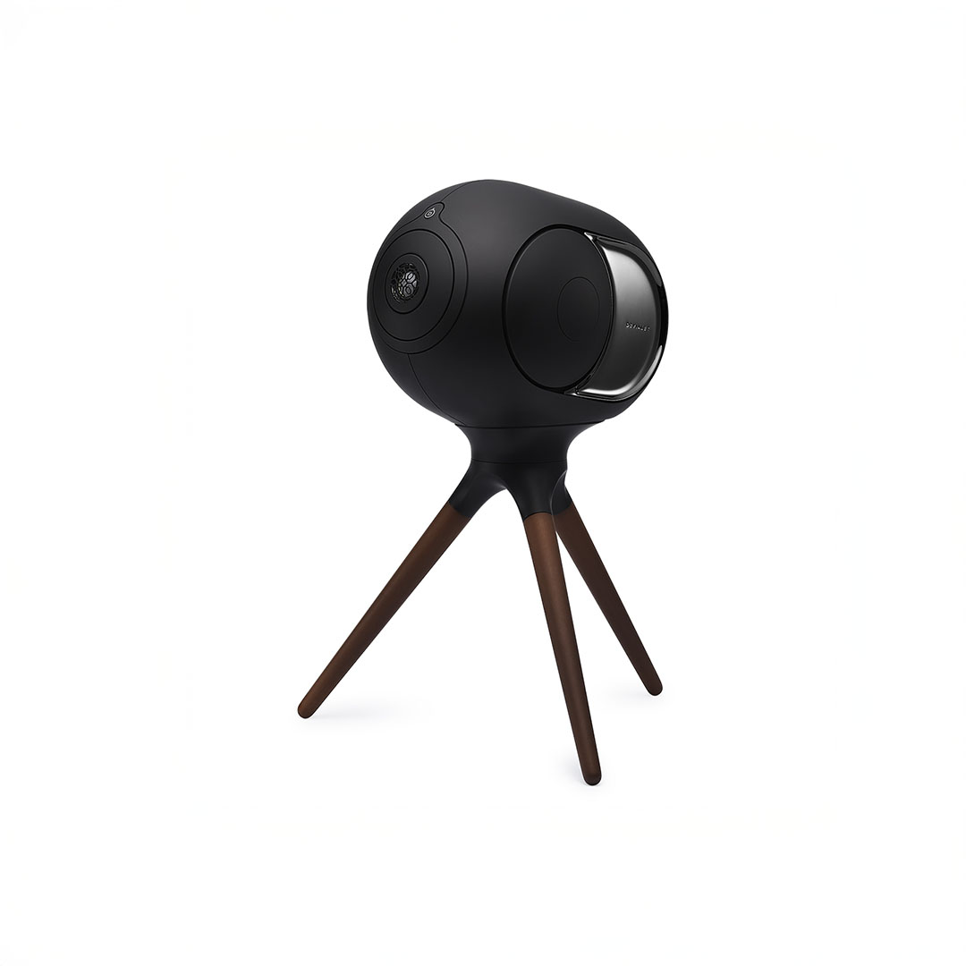 Modern black speaker on wooden tripod stand.