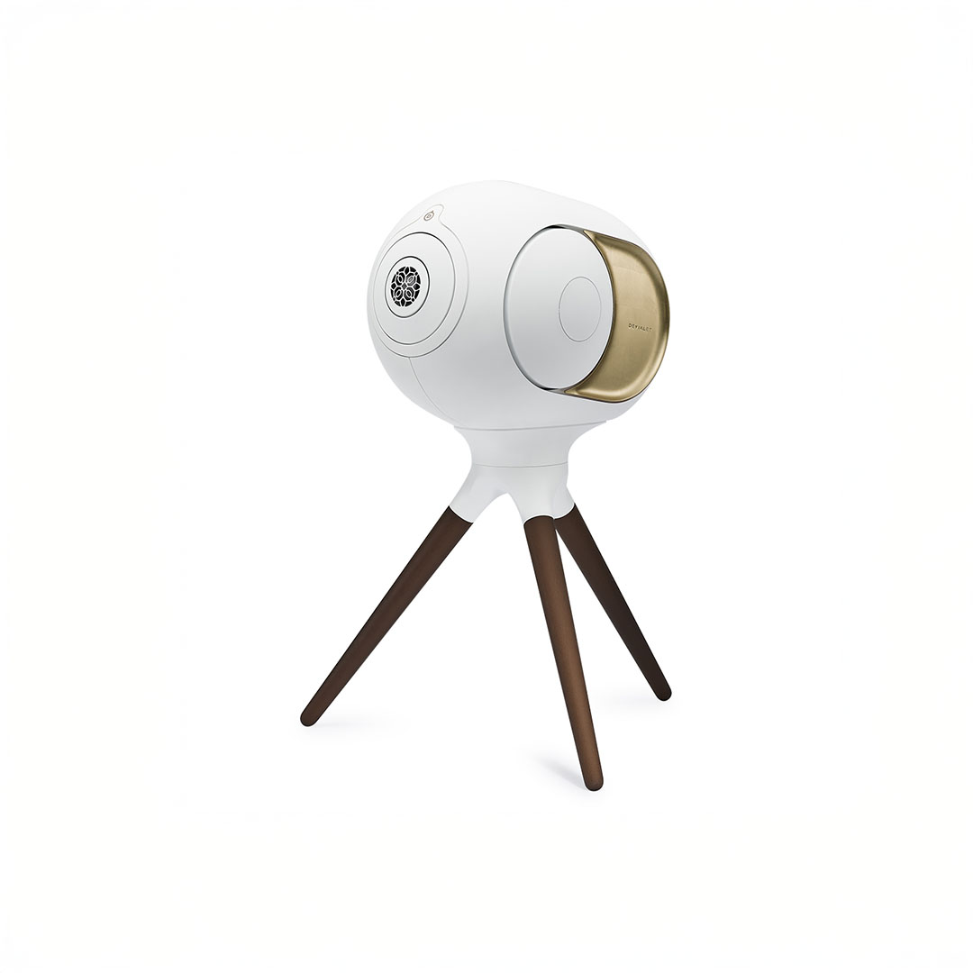 Modern white speaker on wooden tripod stand.