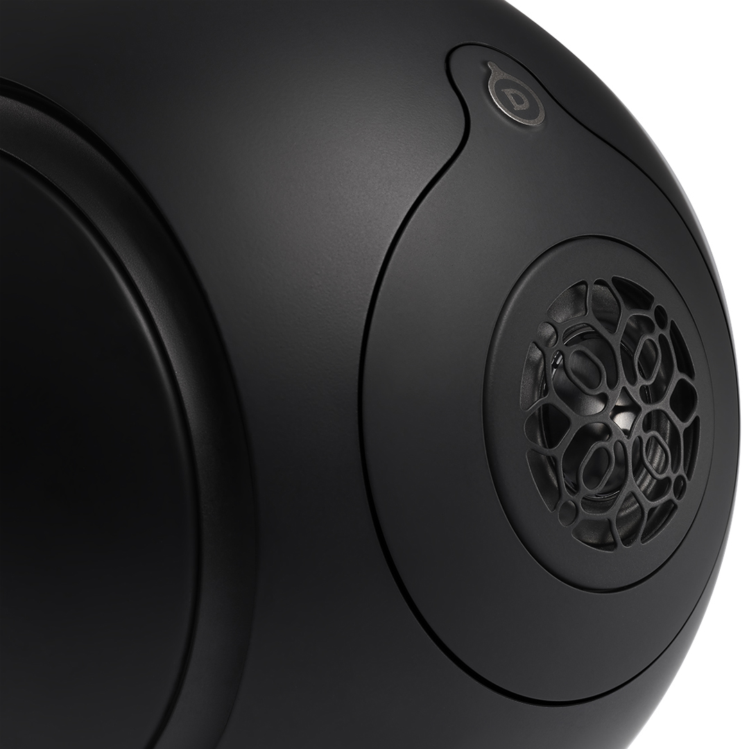 Black spherical speaker with intricate grille design.