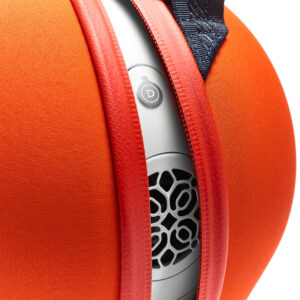 Close-up of orange speaker with intricate grille design.