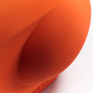 Close-up of textured orange fabric curved surface