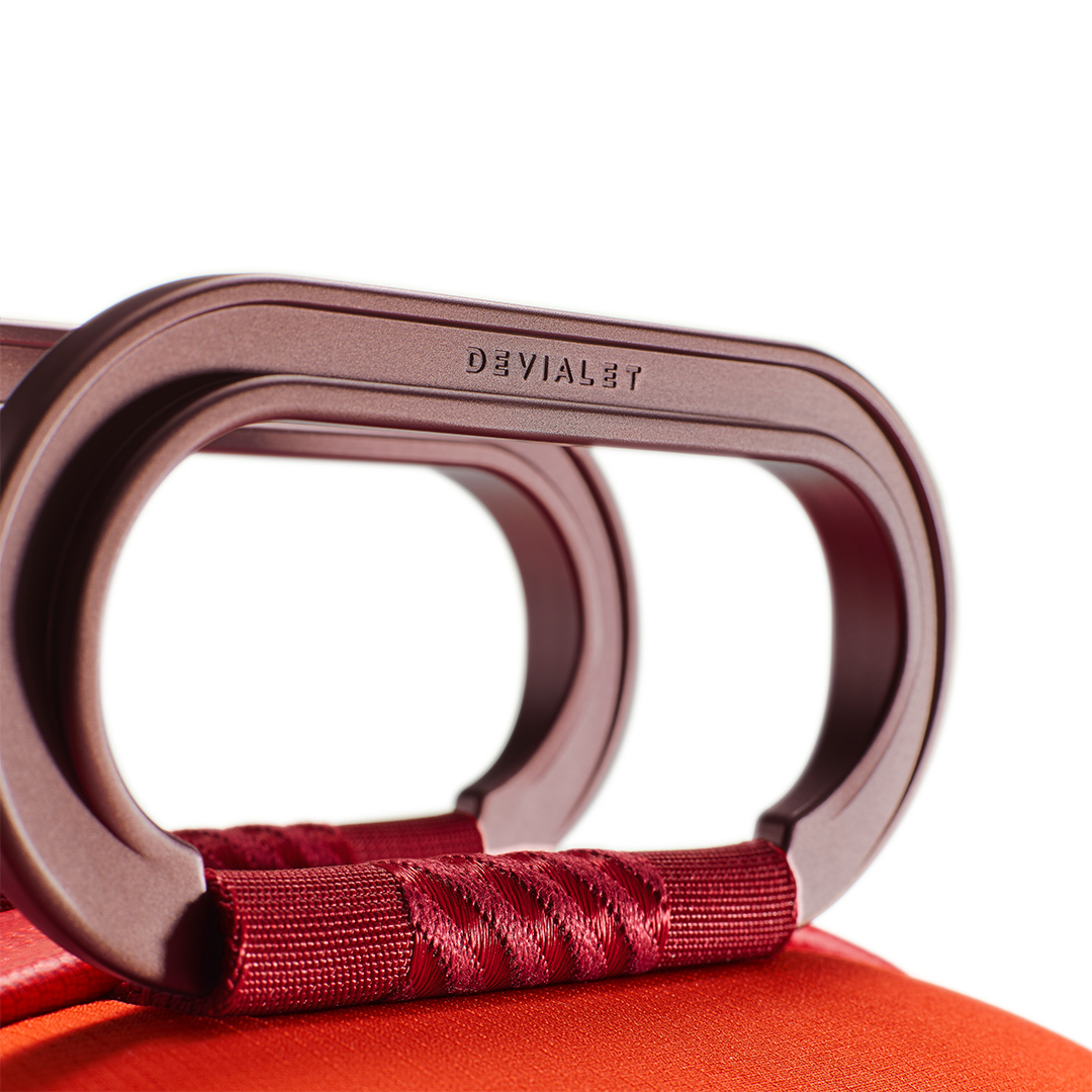 Close-up of stylish bag handle with red accents.