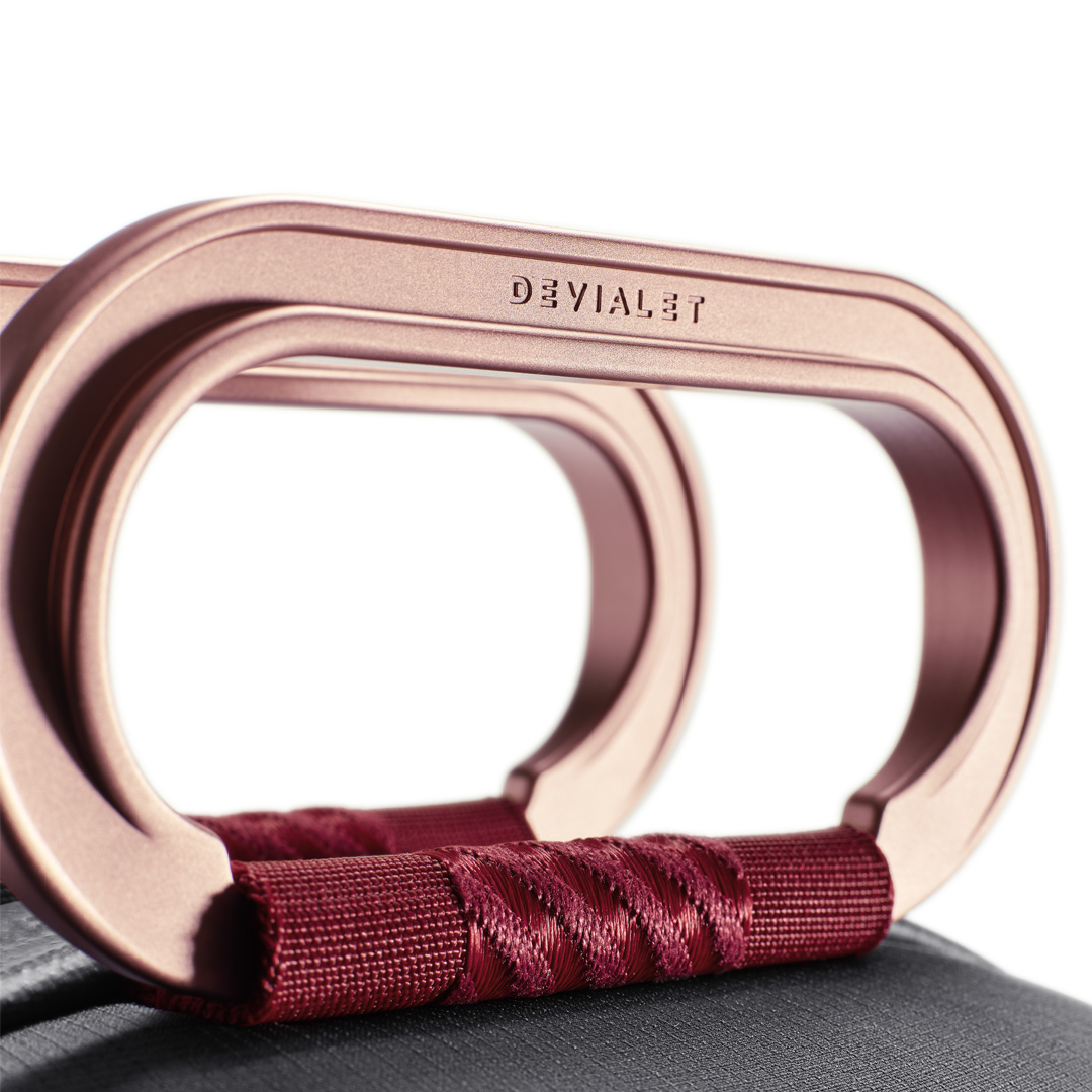 Close-up of rose gold handle with burgundy strap.