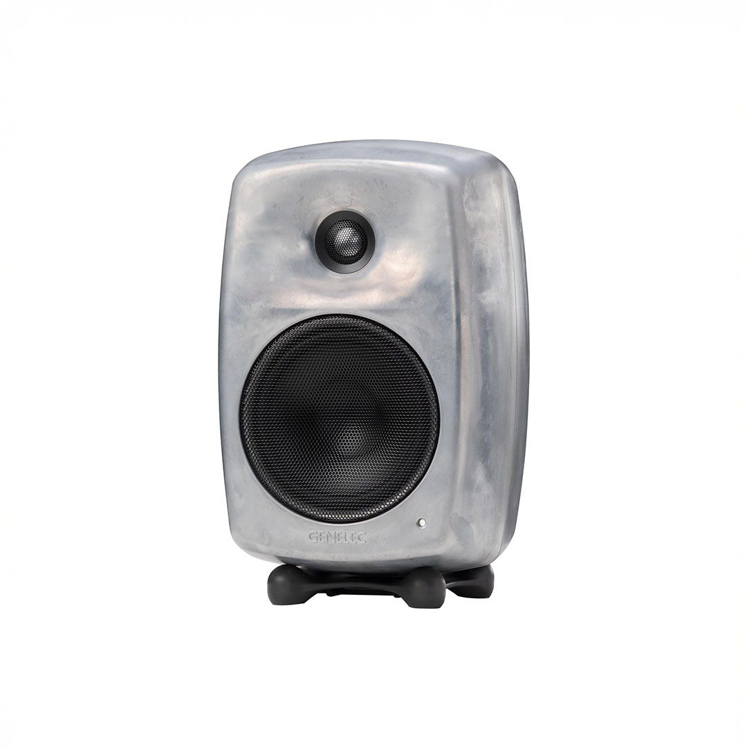 Gray audio speaker with metallic finish and grill.