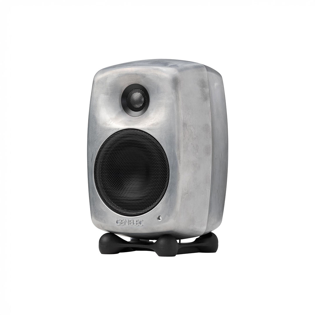 Modern silver audio speaker on stand.