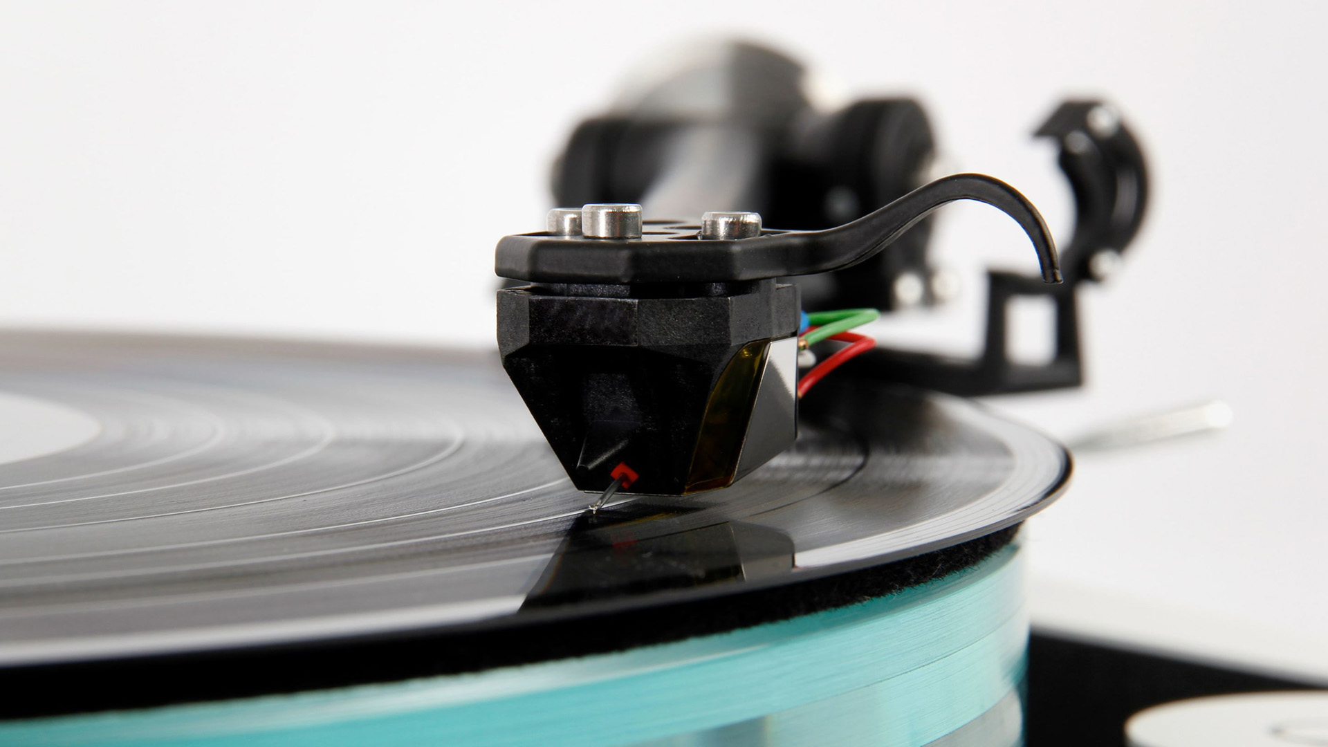 Rega turntable needle on spinning vinyl record