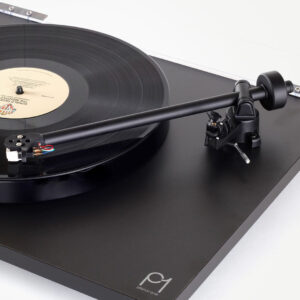 Black vinyl record on turntable with tonearm