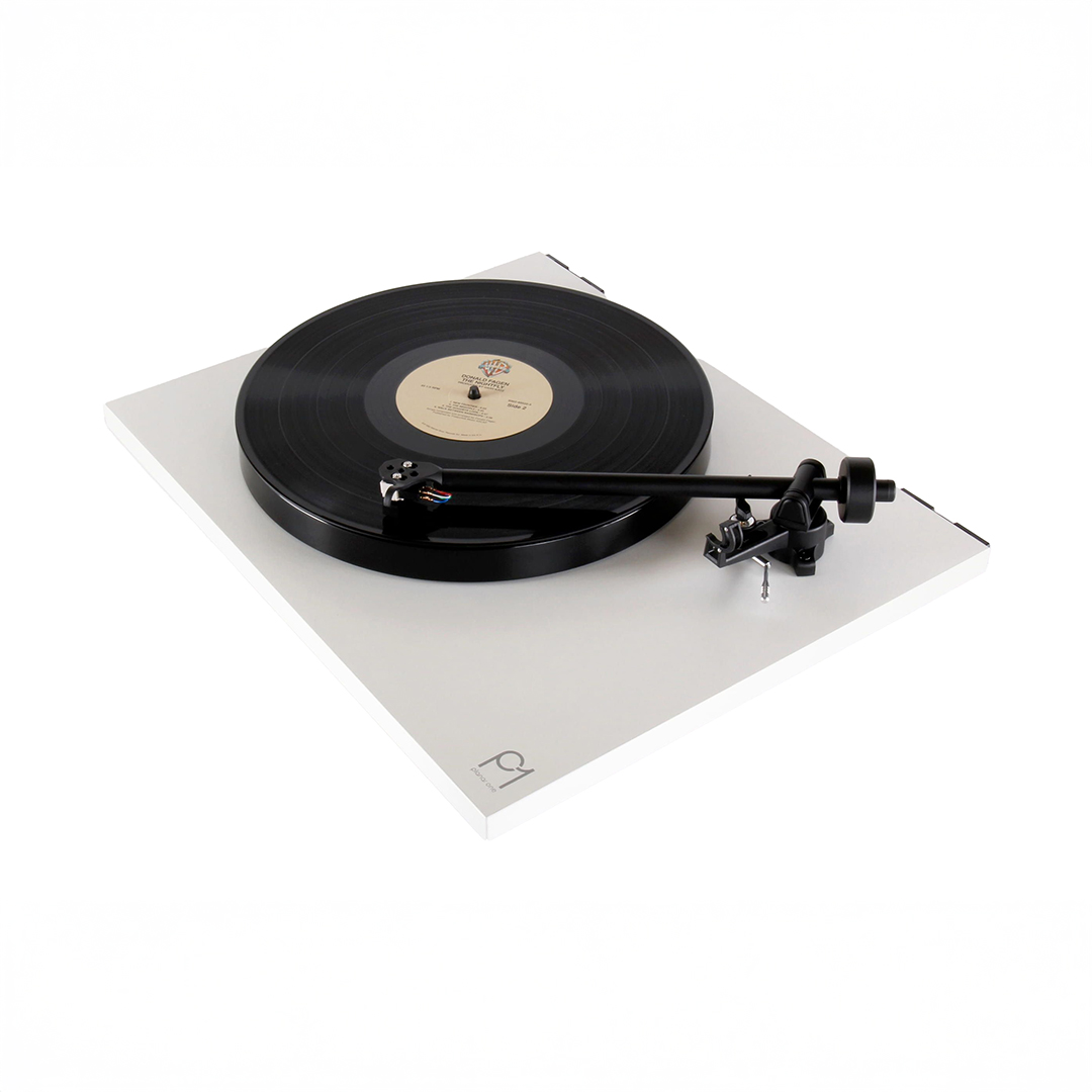 Turntable playing a vinyl record on white background.