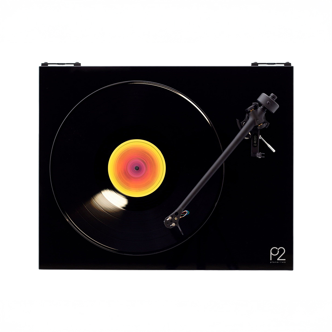 Turntable playing vinyl record with colorful label.