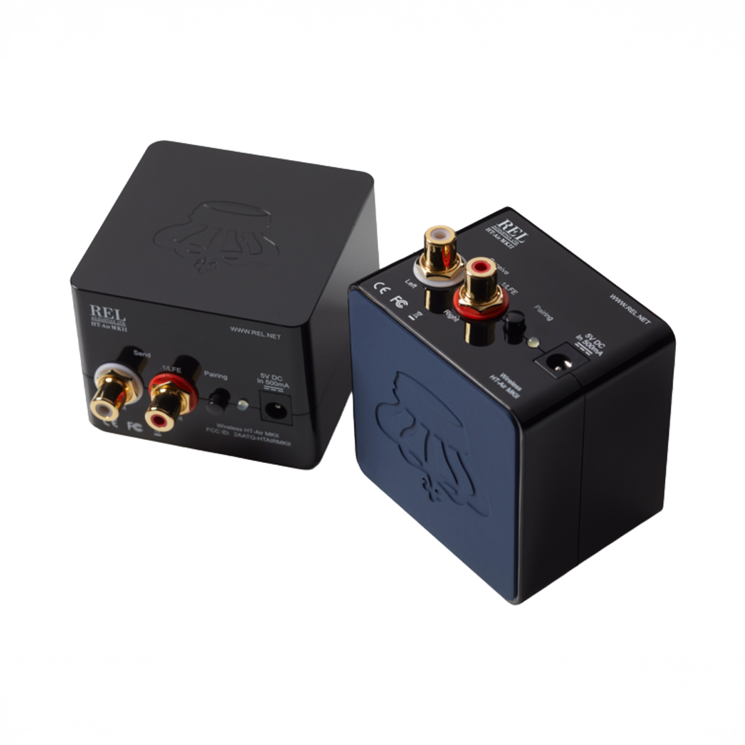 REL subwoofer wireless modules, black cubes with connectors.