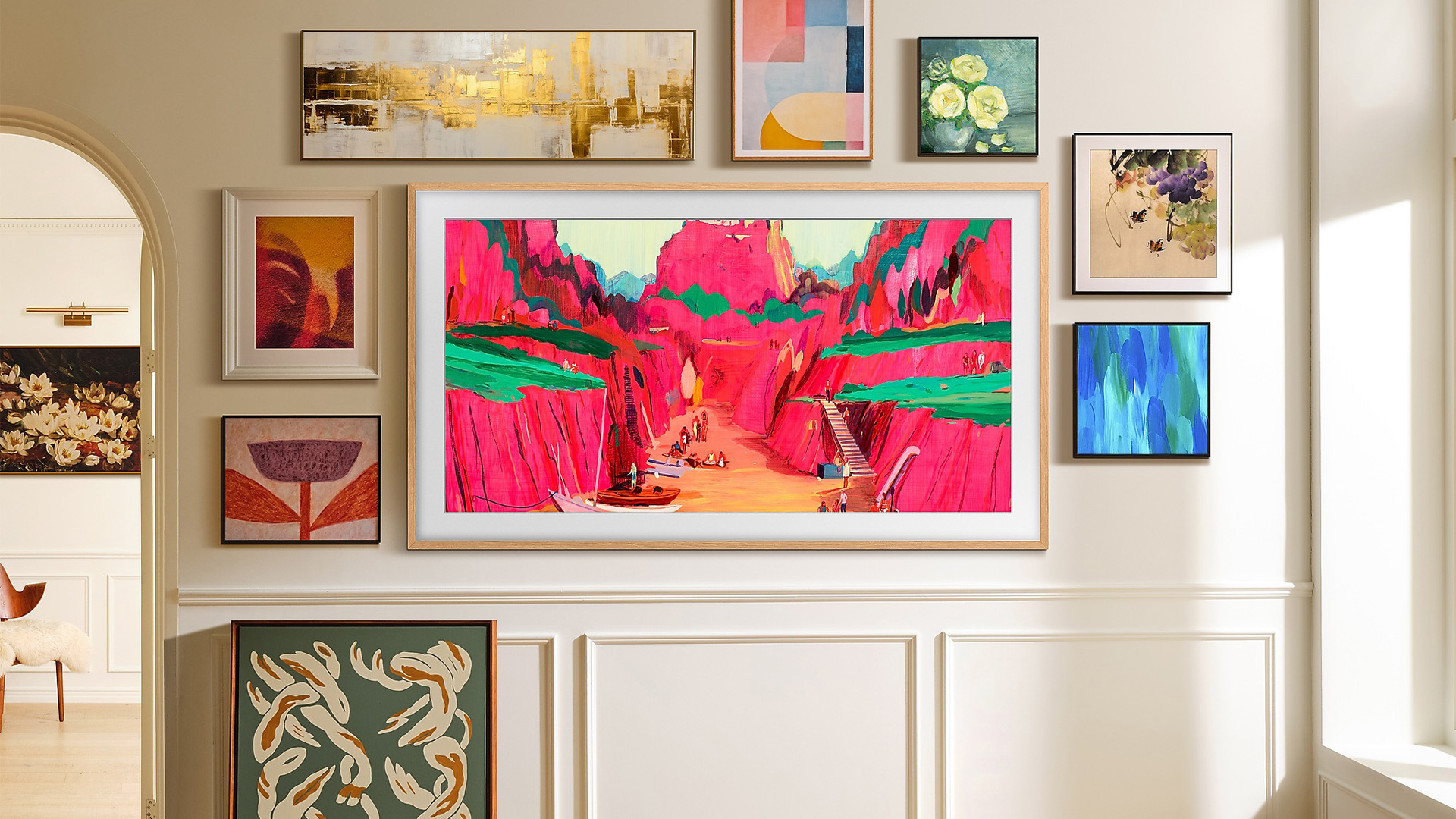 Gallery wall with colorful framed art surrounding a modern Samsung TV