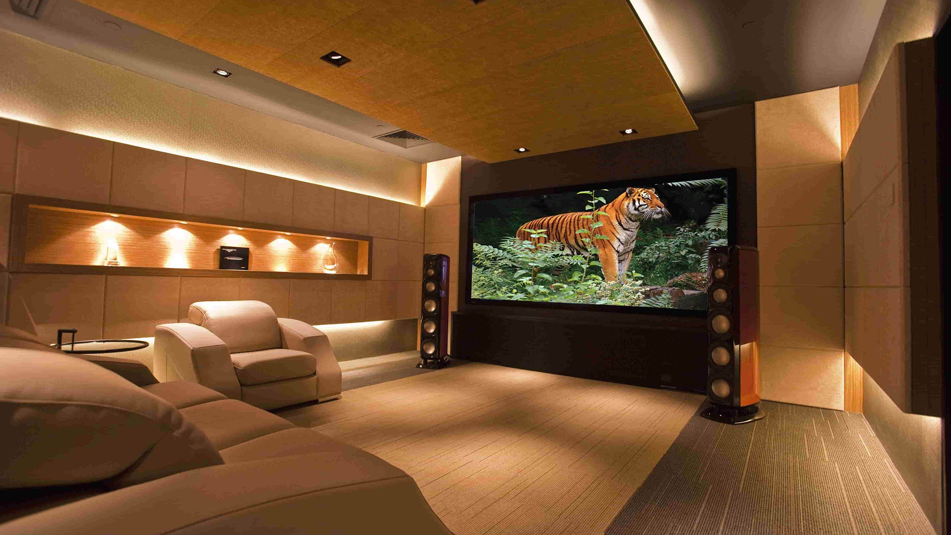 Luxury home theater with large projector screen and beige seating