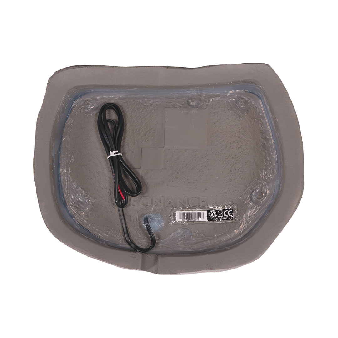 Rear view of rock-shaped outdoor speaker.