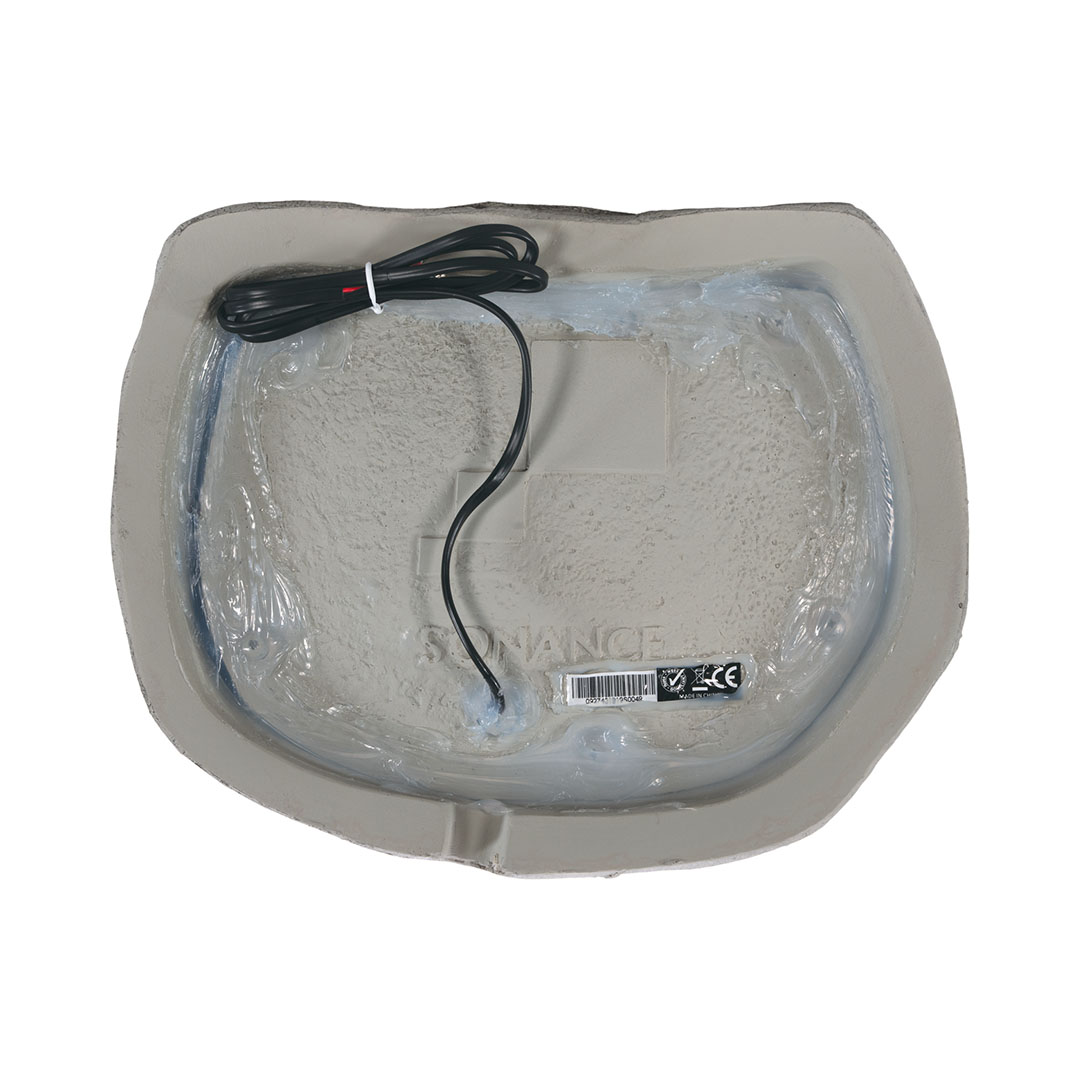 Back view of Sonance rock speaker with cable.