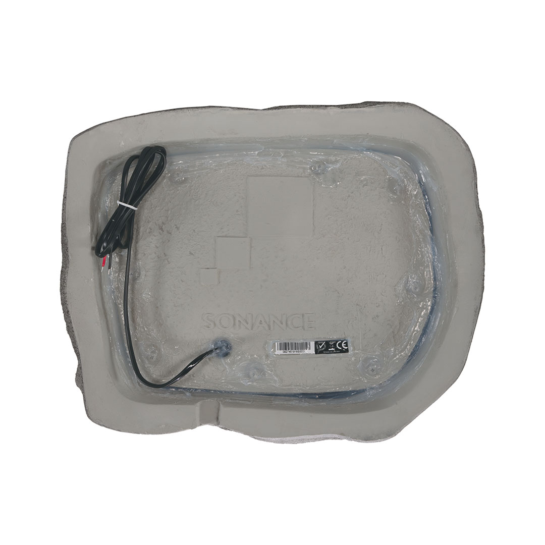 Bottom view of speaker with wire attached.