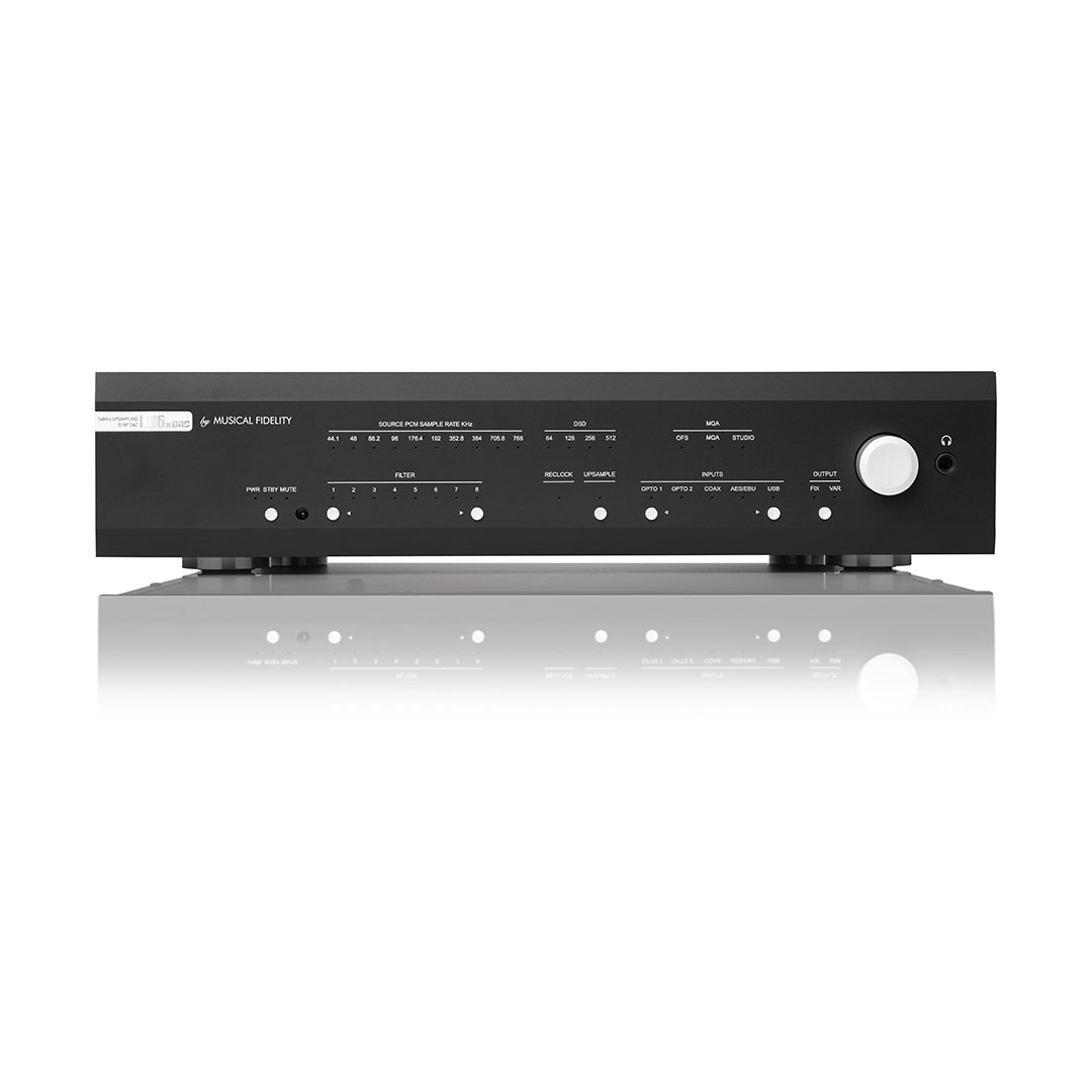 Black stereo amplifier on reflective surface.