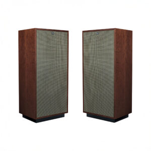 Two vintage wooden speakers with fabric fronts.
