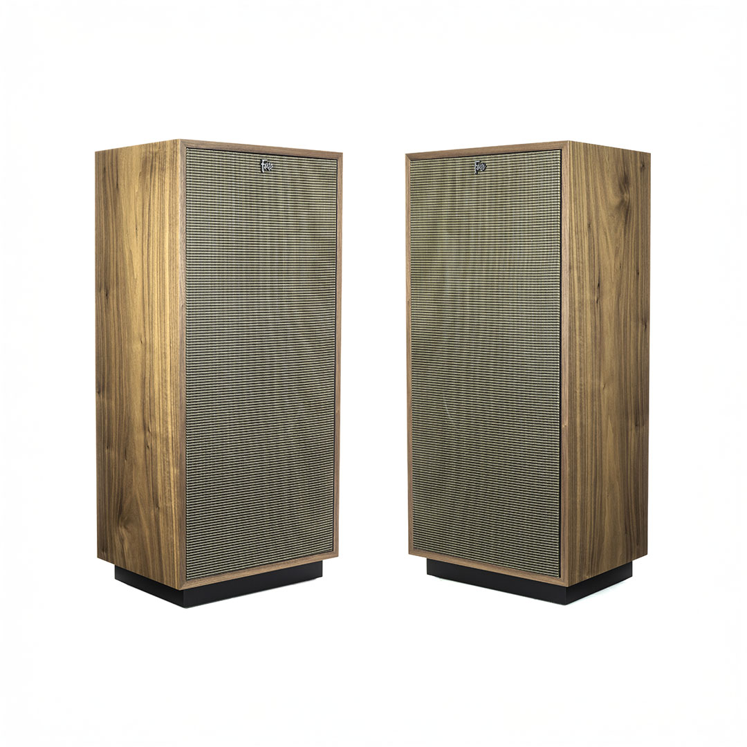 Pair of vintage wooden speakers with grille covers.